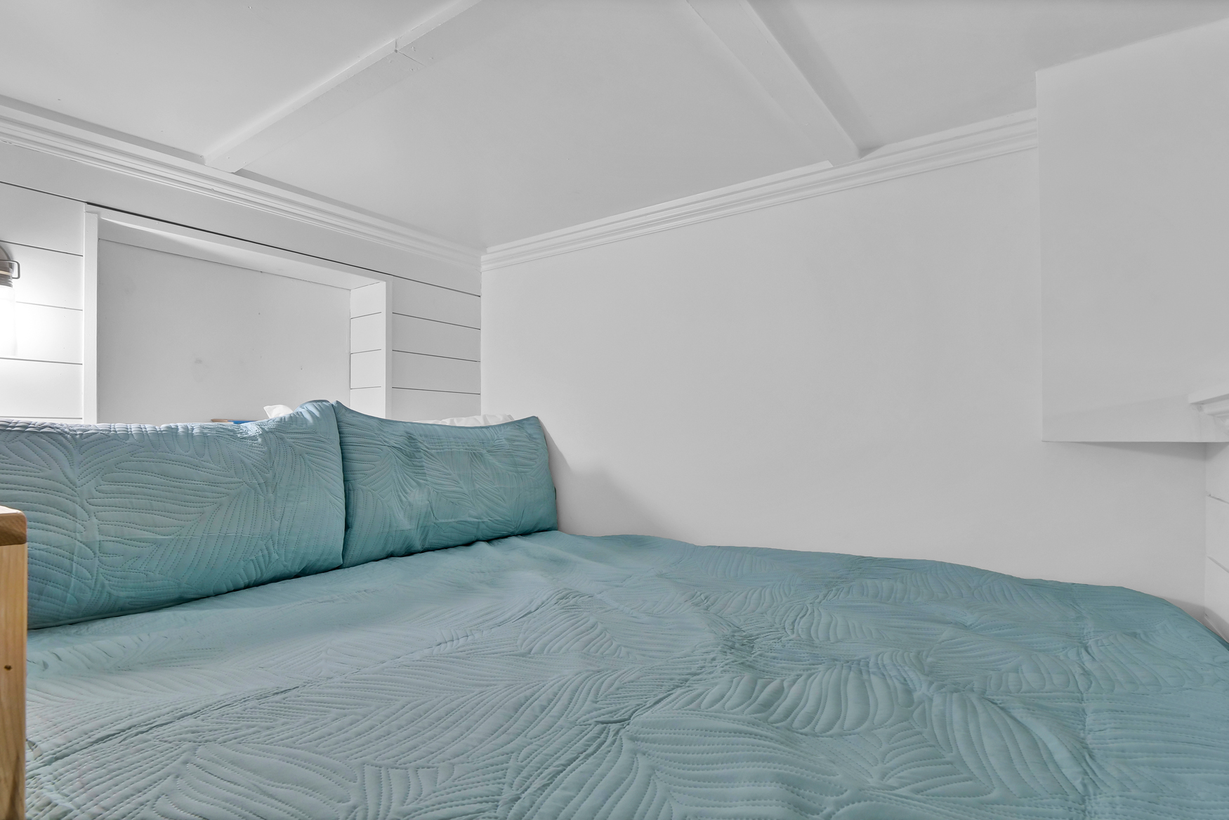 Bedroom loft with storage and soft lighting